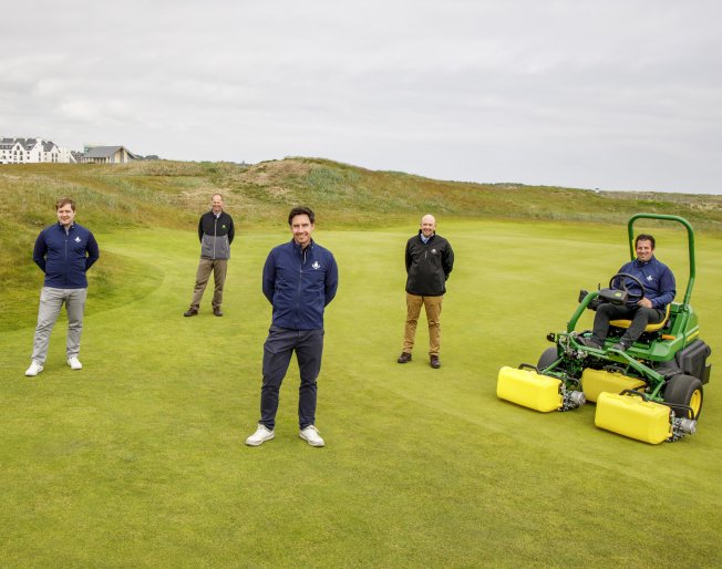 Carnoustie Golf Links Chief Executive Michael Wells (centre front) with (left to right) Deputy Chief Executive Adair Simpson, John Deere Strategic Account Manager Richard Charleton, Managing Director Sandy Armit of John Deere dealer Double A and Links Superintendent Craig Boath, seated on the new John Deere 2750 E-Cut hybrid electric greens mower.