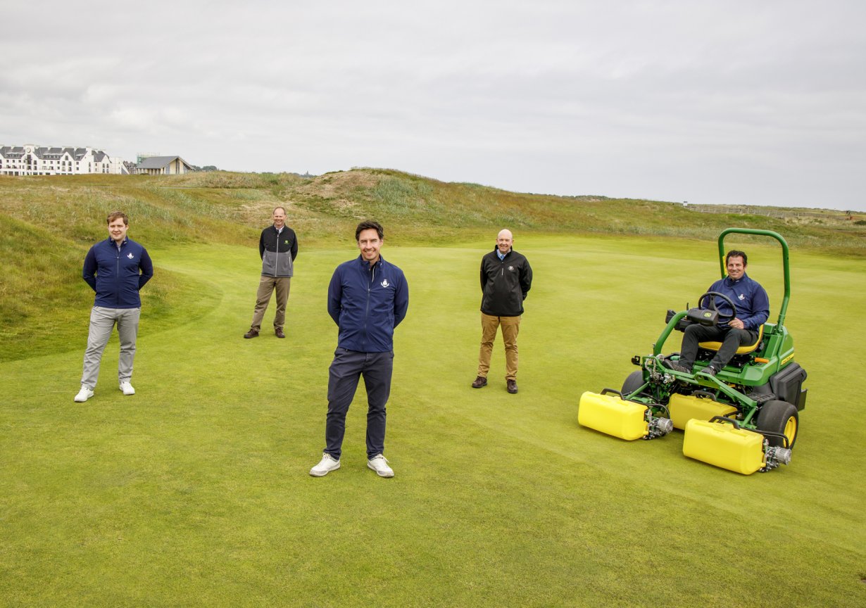 Carnoustie Golf Links Chief Executive Michael Wells (centre front) with (left to right) Deputy Chief Executive Adair Simpson, John Deere Strategic Account Manager Richard Charleton, Managing Director Sandy Armit of John Deere dealer Double A and Links Superintendent Craig Boath, seated on the new John Deere 2750 E-Cut hybrid electric greens mower.